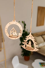 Wooden Christmas decorations hanging in a room with a plant and furniture in the background.