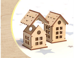 Two wooden house models with a snowy background