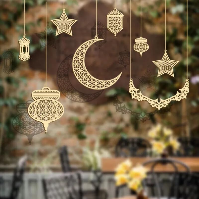 Decorative gold moon and star ornaments hanging against a blurred outdoor background.