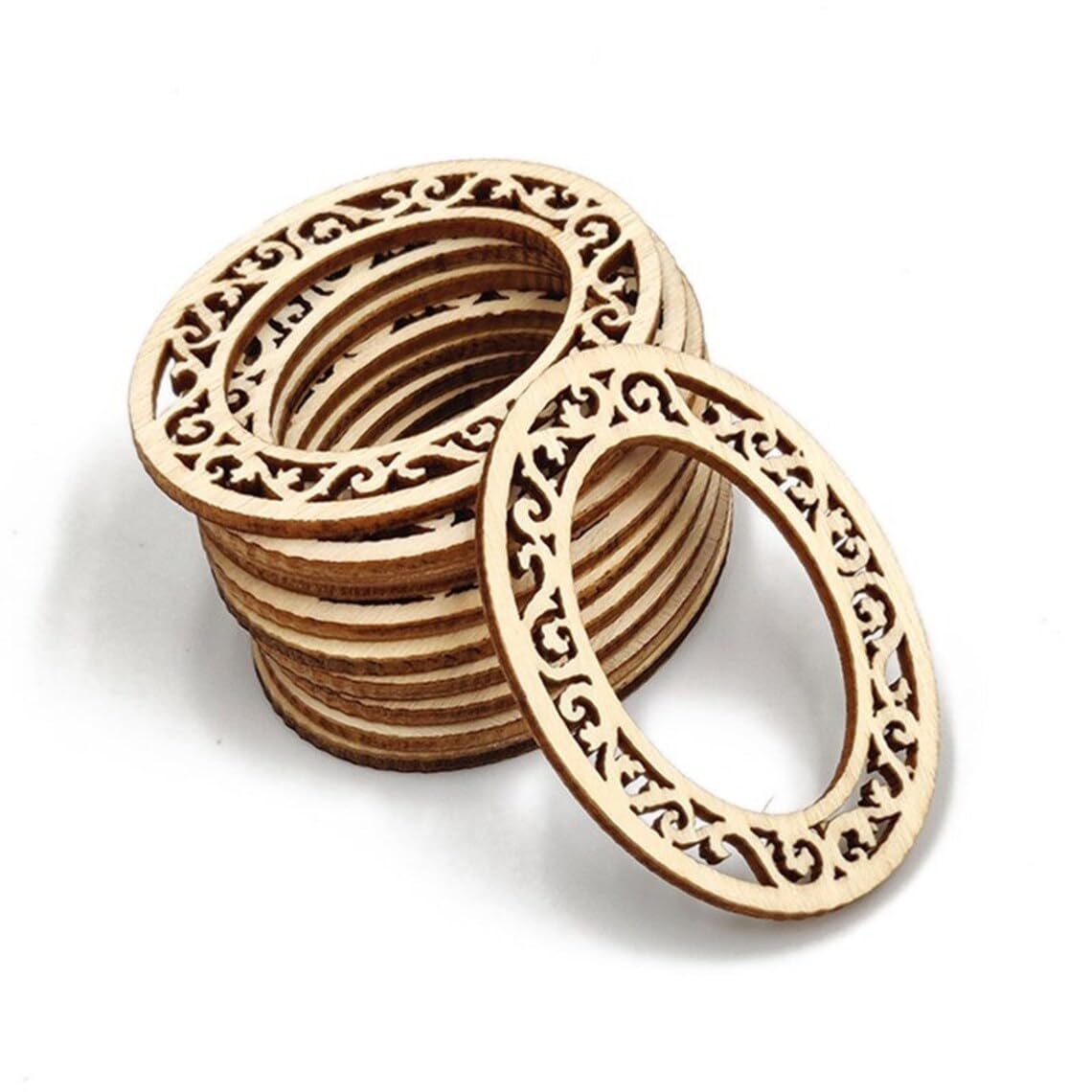 Stack of wooden coasters with intricate cut-out patterns on a white background