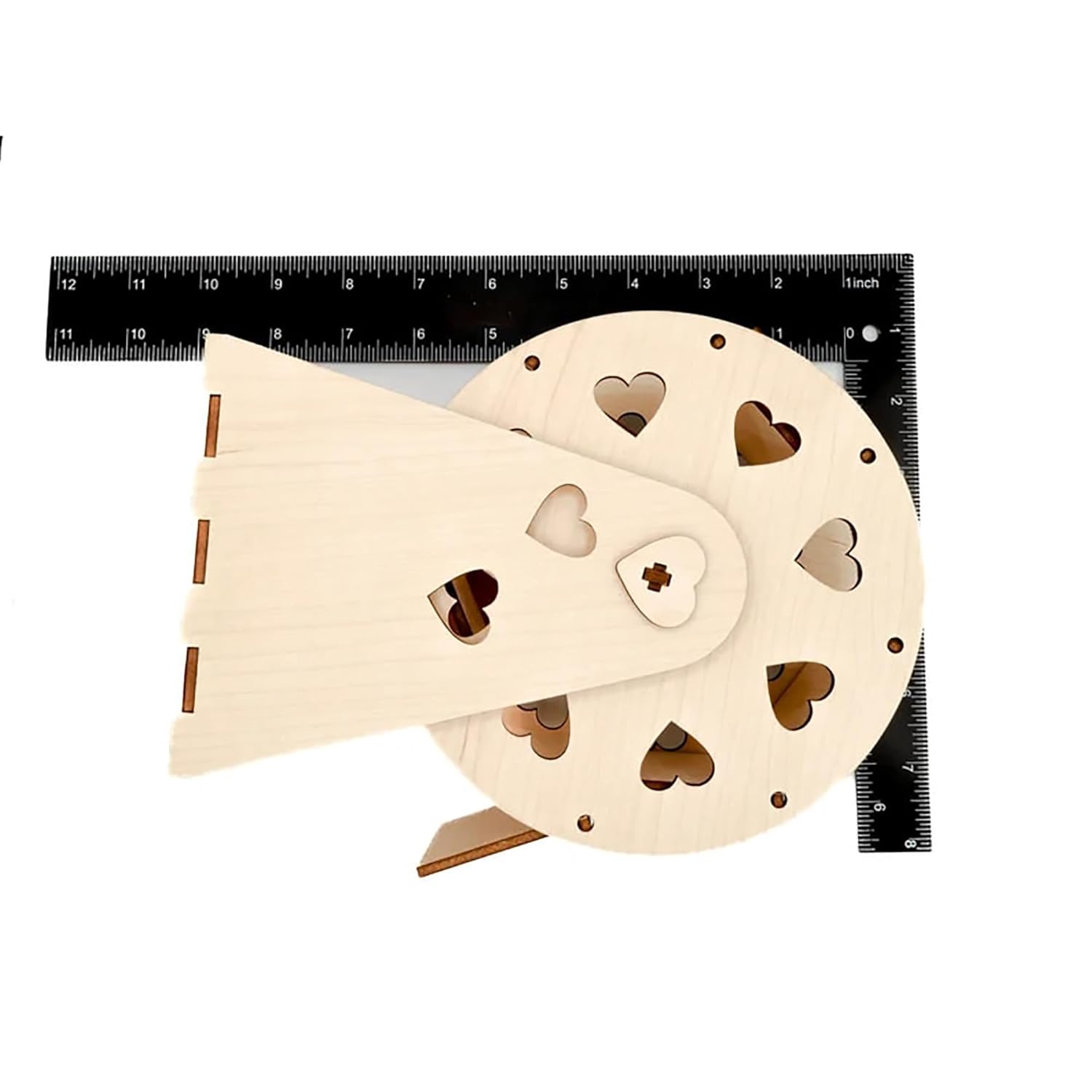 Wooden puzzle with heart shapes next to a ruler on a white background
