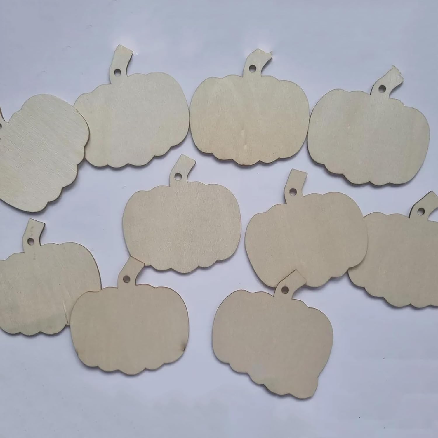 Beige pumpkin-shaped tags on a white background