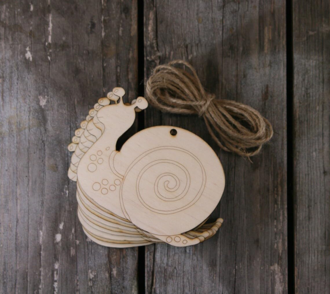 Wooden snail-shaped ornament with string on a rustic wooden background