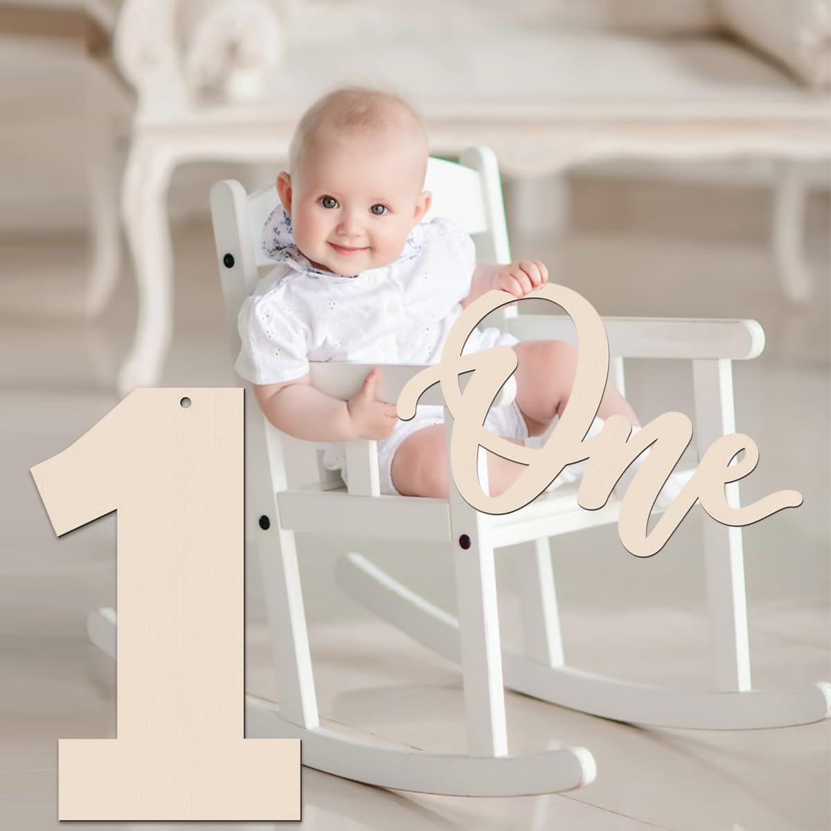 Baby sitting in a high chair with wooden numbers '1' and 'One' displayed.