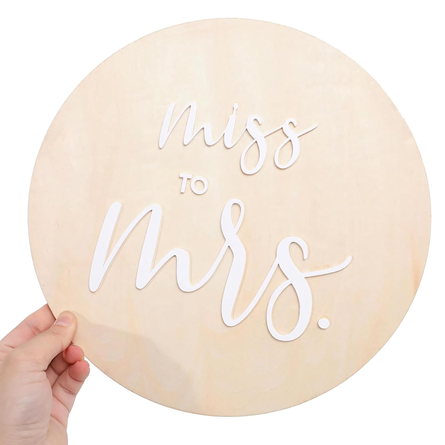 Round wooden sign with 'Miss to Mrs.' text on a white background