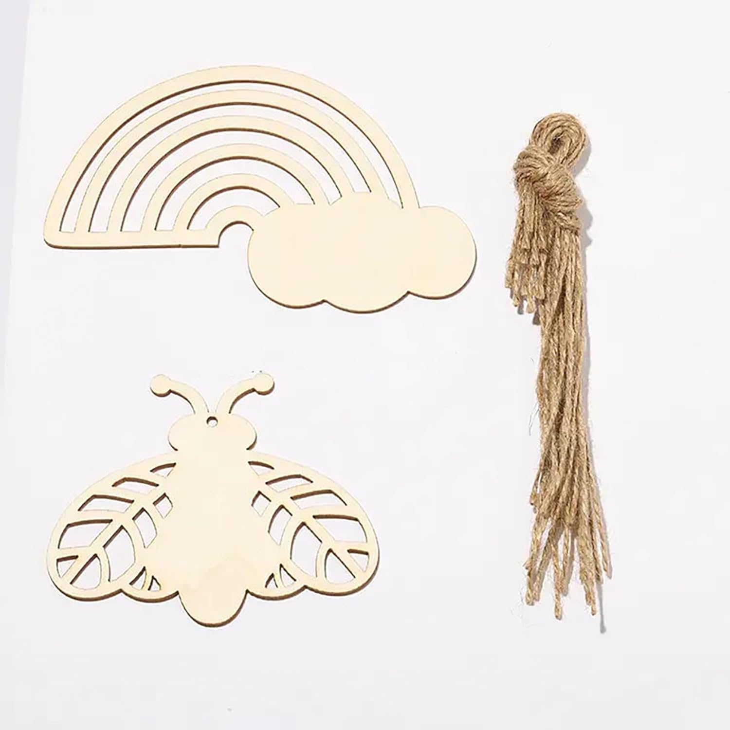 Wooden rainbow, cloud, and butterfly shapes with twine on a white background
