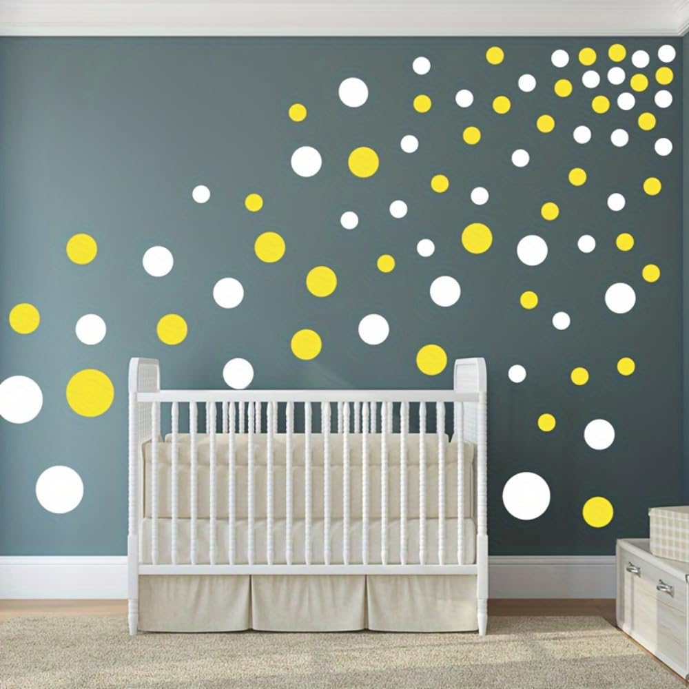 Nursery room with a crib and polka dot wall decors on a gray wall.