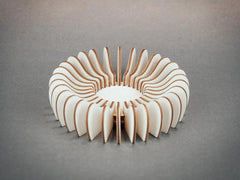 Wooden fan-like object on a gray background
