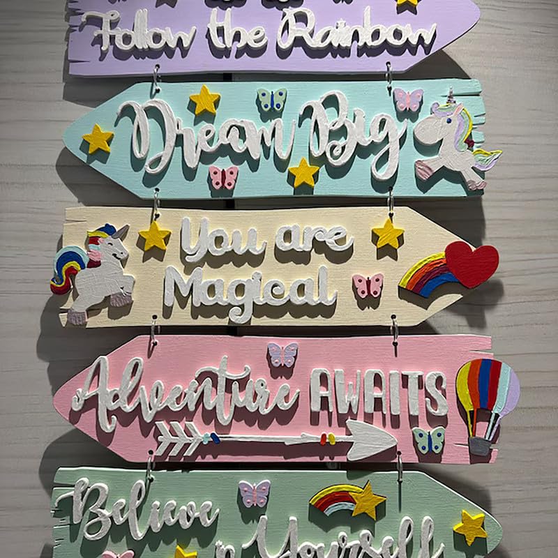 Set of colorful wooden signs with motivational phrases and graphics on a wooden surface.
