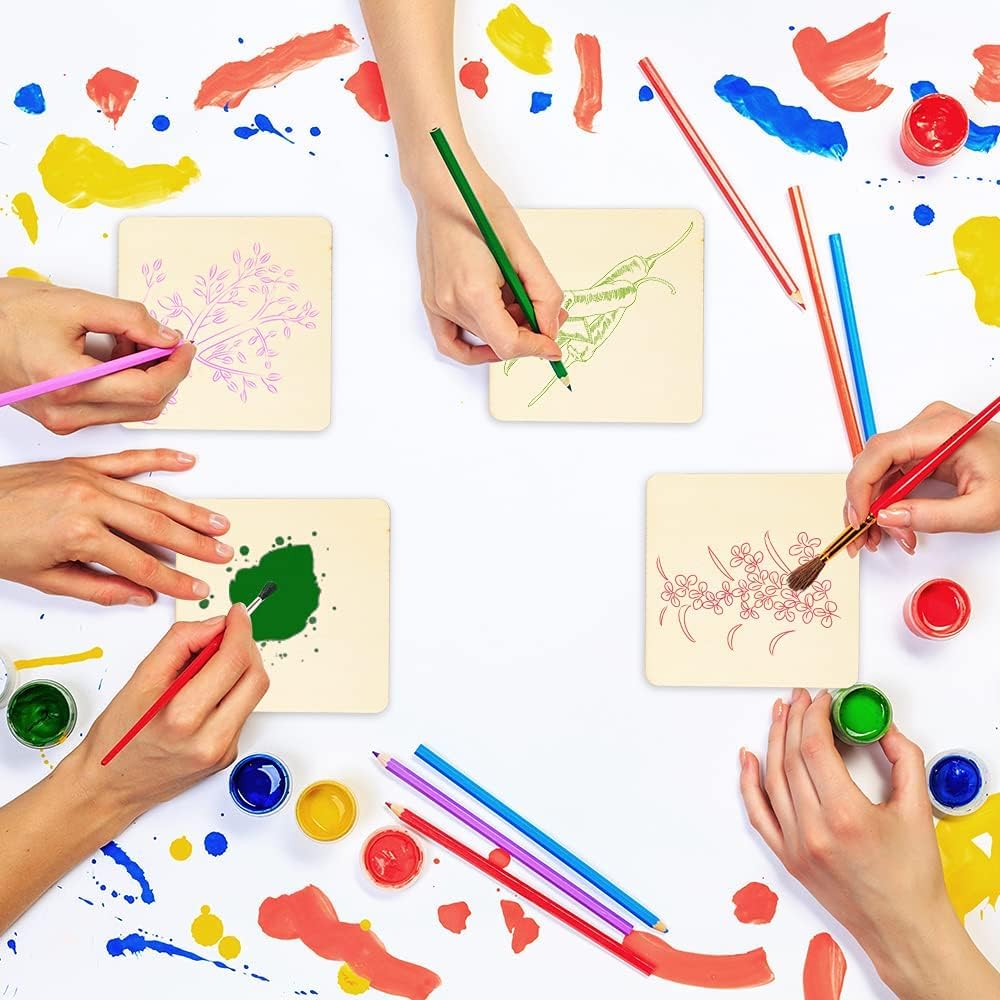 Children's hands painting on paper with colorful paints and brushes on a white surface.
