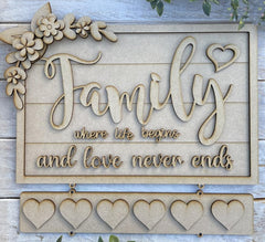 Decorative sign with 'Family where life begins and love never ends' text on a wooden background.