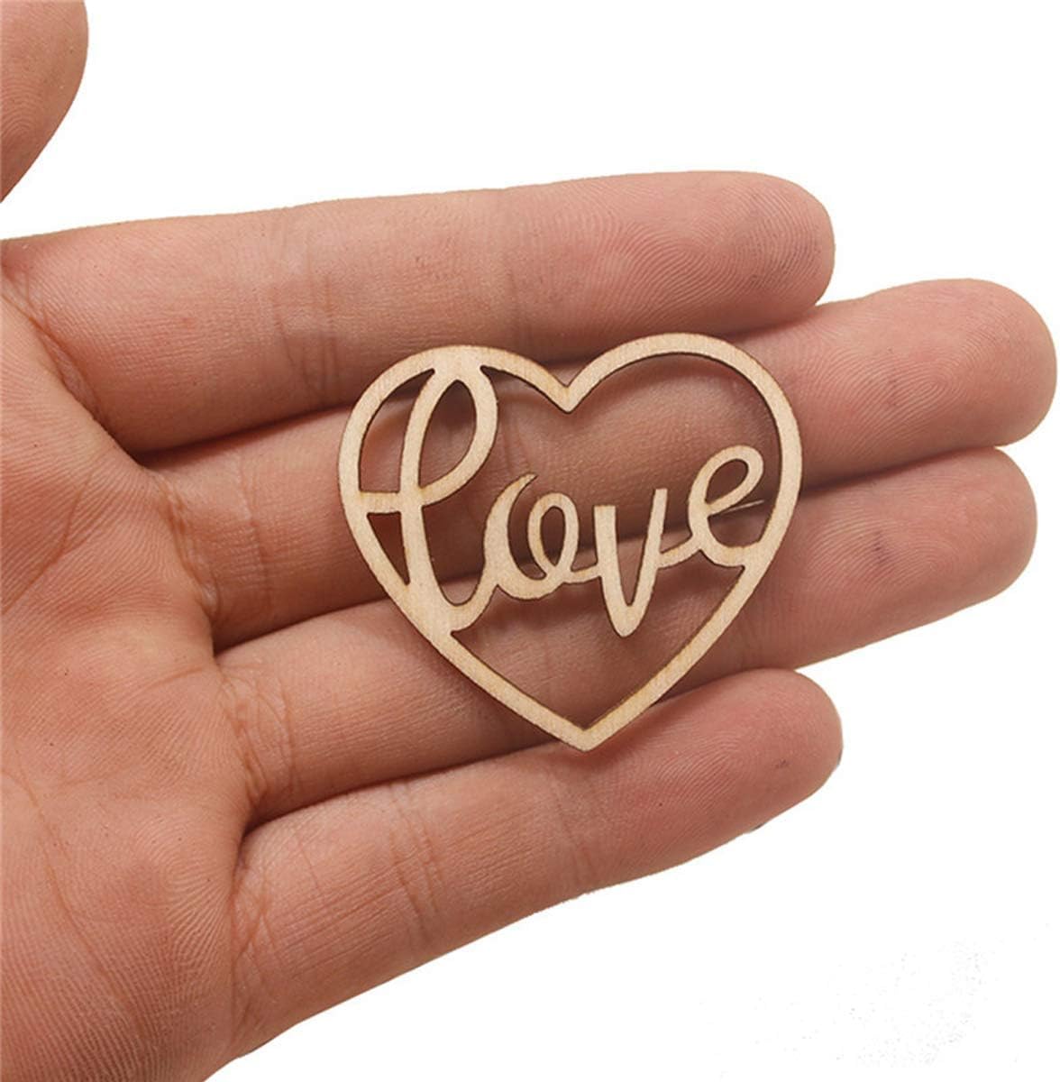 Wooden heart-shaped cutout with 'love' inside held in a hand on a white background