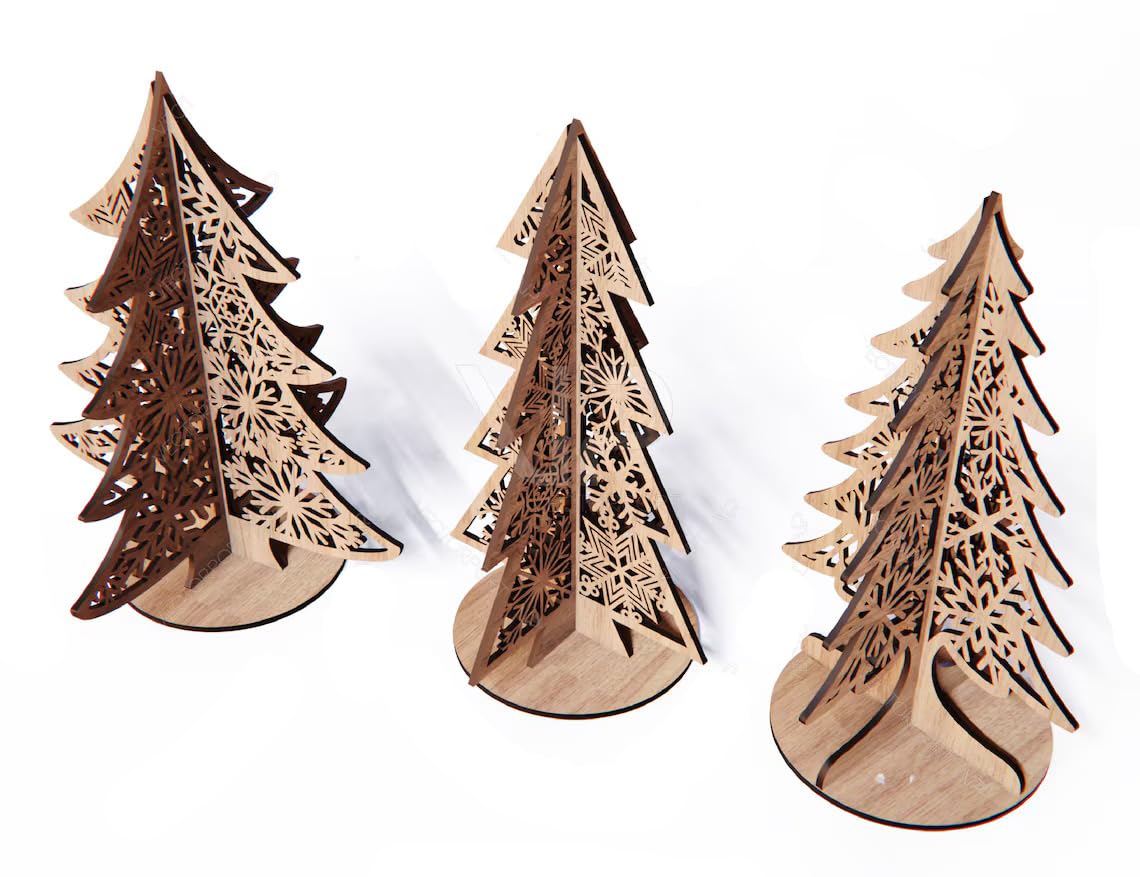 Three wooden Christmas tree decorations with intricate cut-out designs on a white background