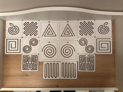 Wooden panel with geometric and natural patterned tiles on a neutral background