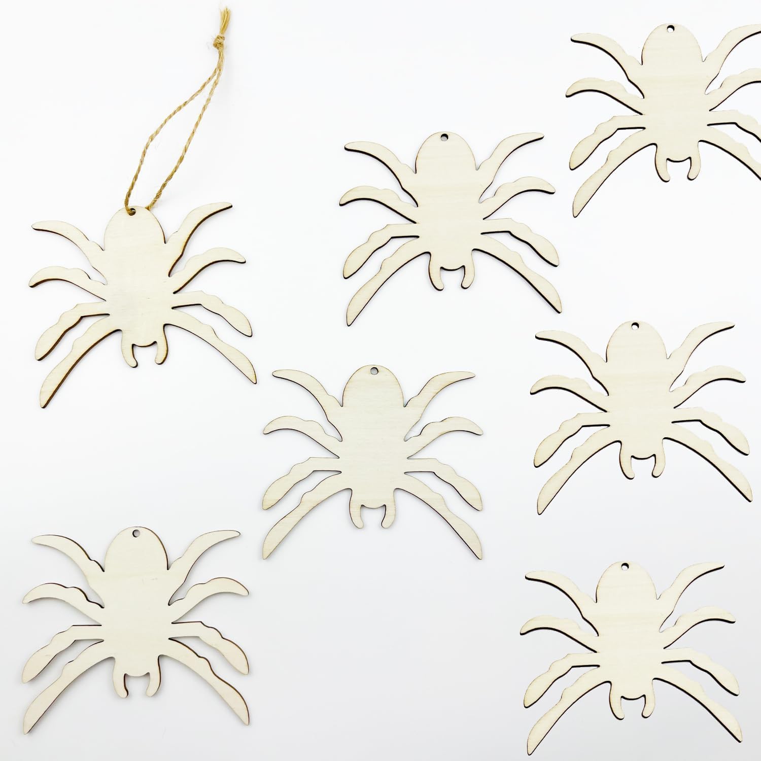 Set of white spider-shaped ornaments on a white background