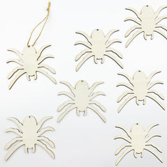 Set of white spider-shaped ornaments on a white background