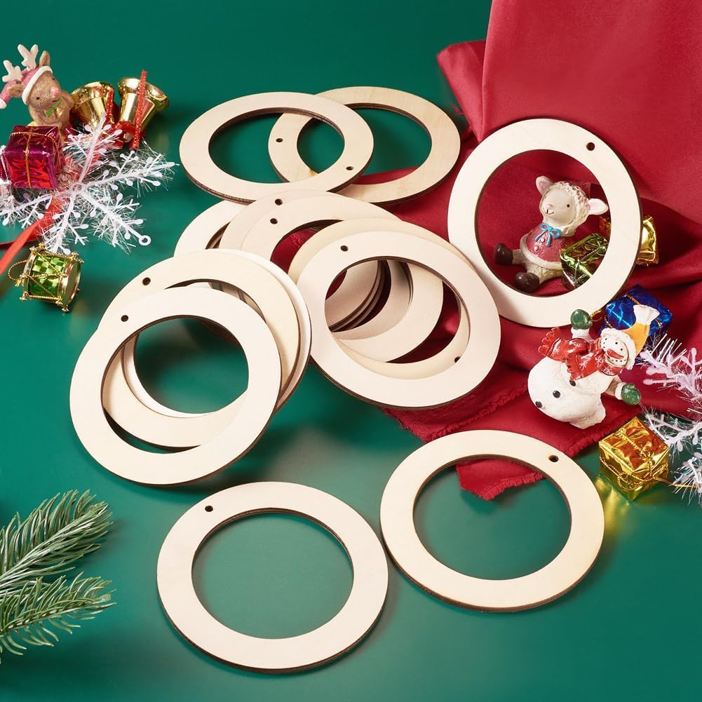 Wooden circular cutouts on a green surface with Christmas decorations.