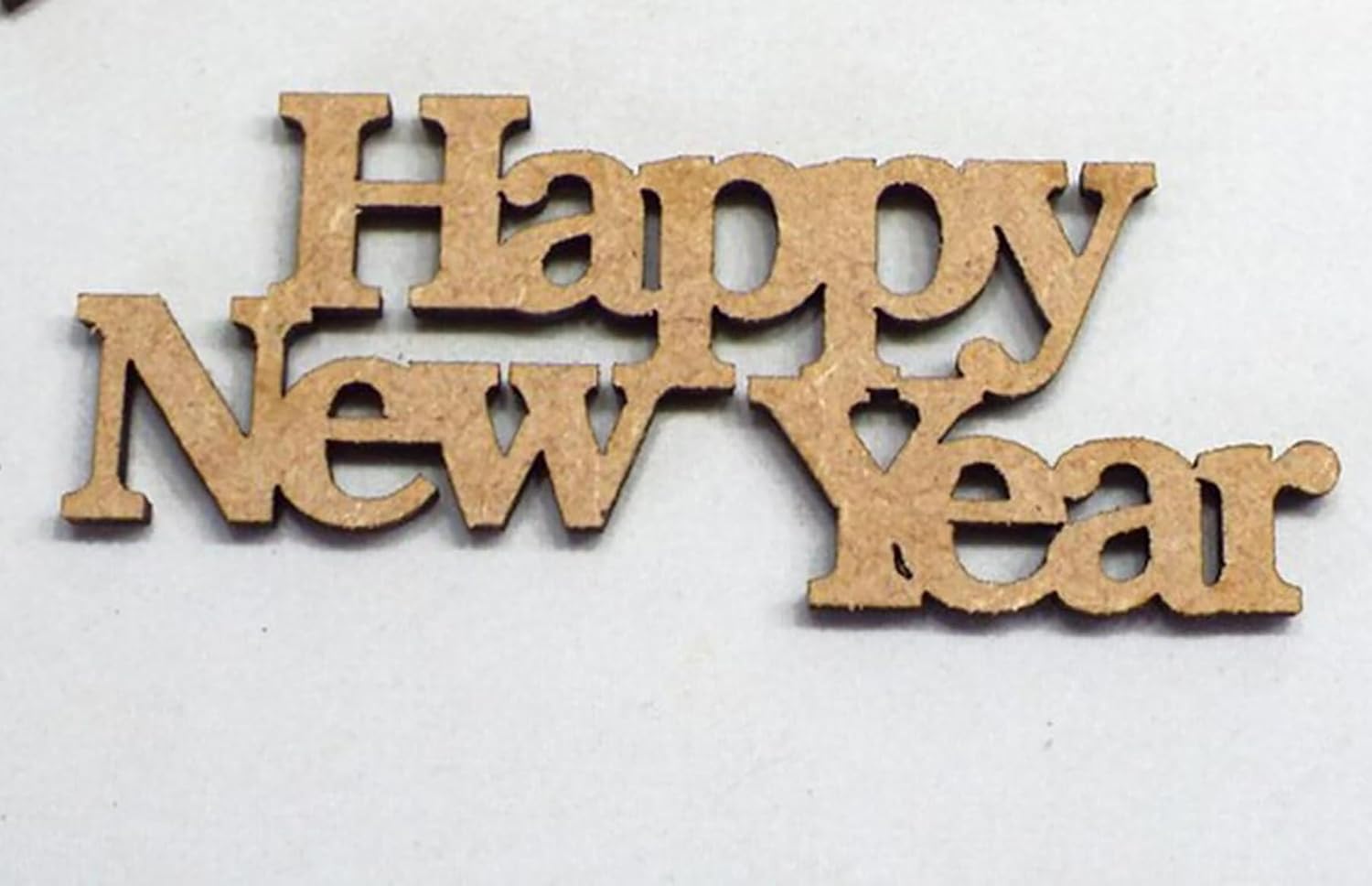 Wooden 'Happy New Year' decoration on a white background