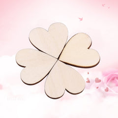 Wooden heart-shaped four-leaf clover on a pink background with heart shapes and flowers.