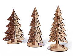 Three wooden Christmas tree decorations with laser-cut patterns on a white background