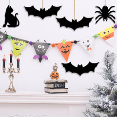 Halloween-themed decorations including bats, a cat, a skeleton, and a tree on a white background.