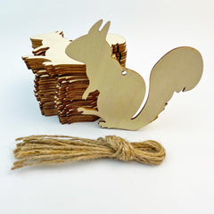 Wooden squirrel-shaped cutouts with twine on a light blue background