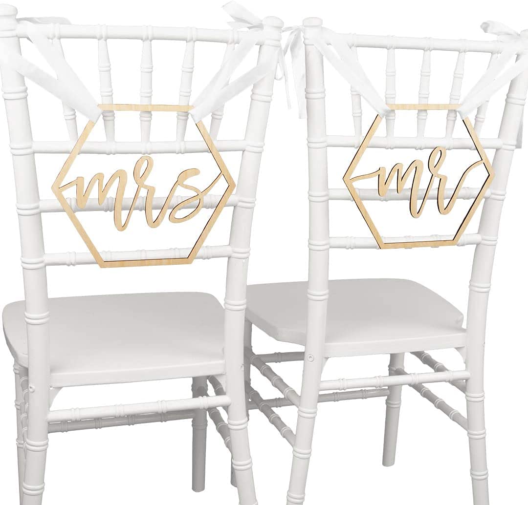 Two white chairs with gold 'Mr' and 'Mrs' signs on a white background
