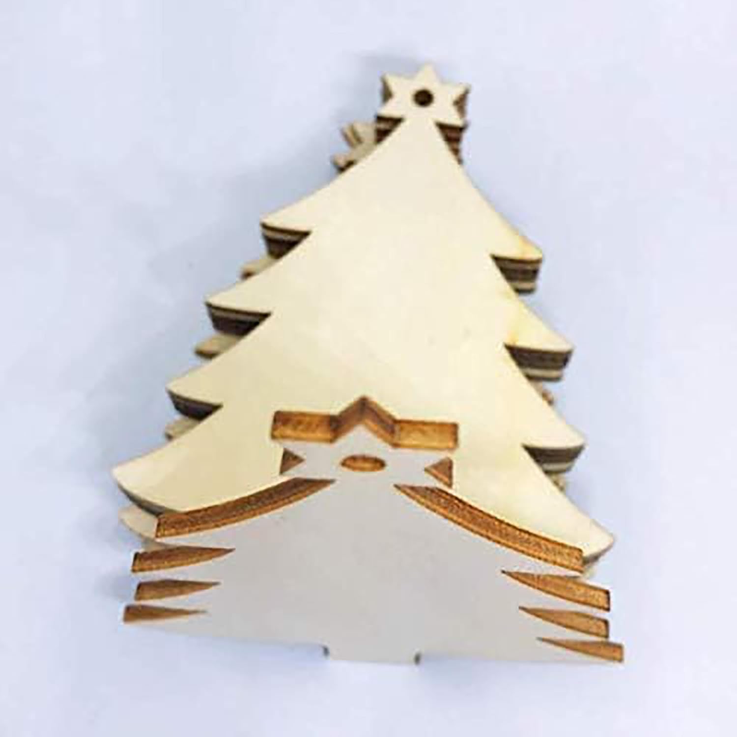 Wooden Christmas tree ornament on a light gray background