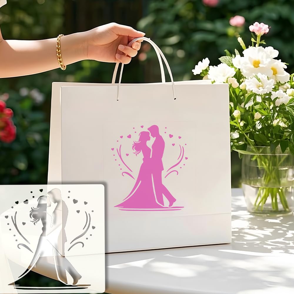 White gift bag with pink silhouette design of a couple, held by a hand, with flowers in the background.