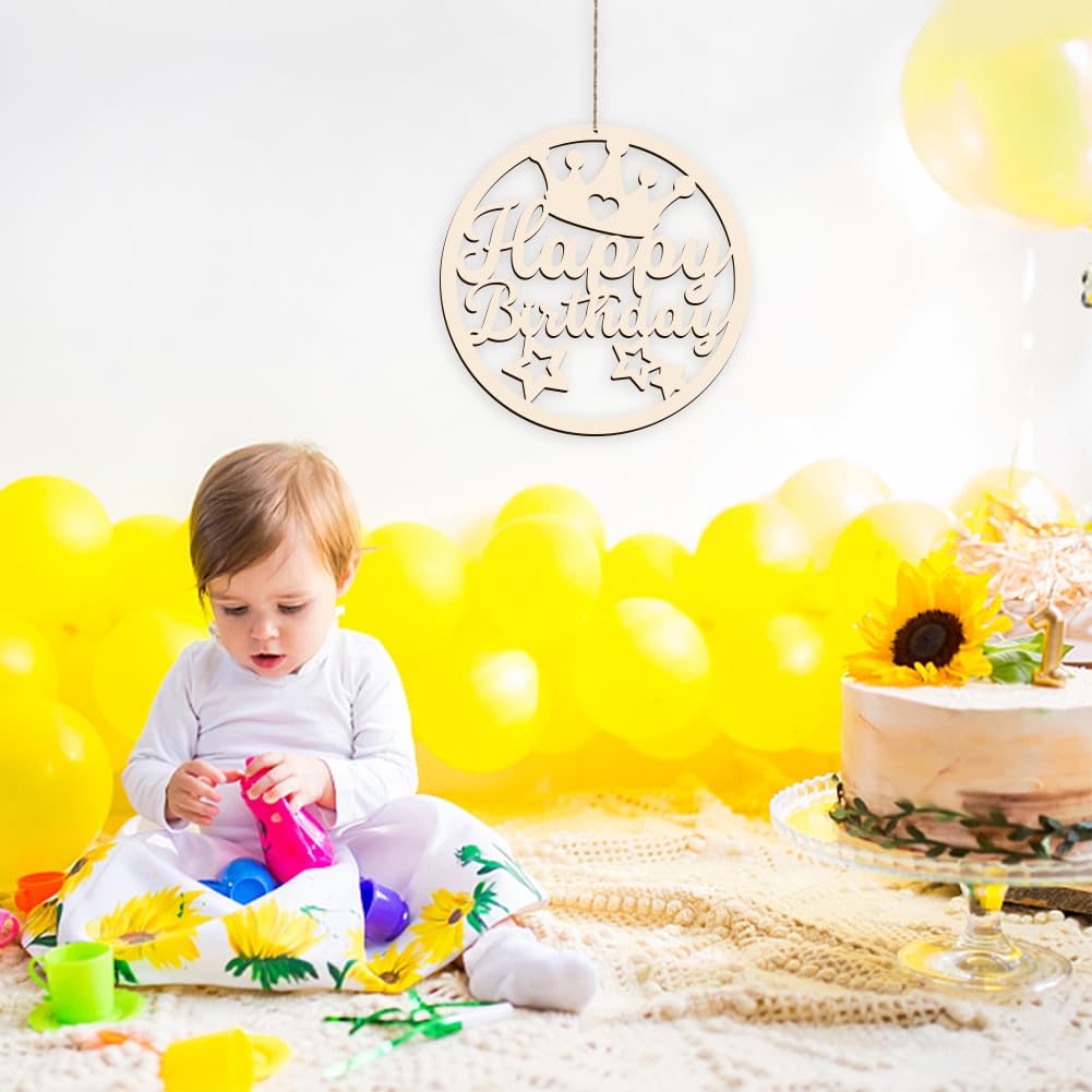 Child playing with toys on a white blanket with yellow balloons and a 'Happy Birthday' sign in the background.
