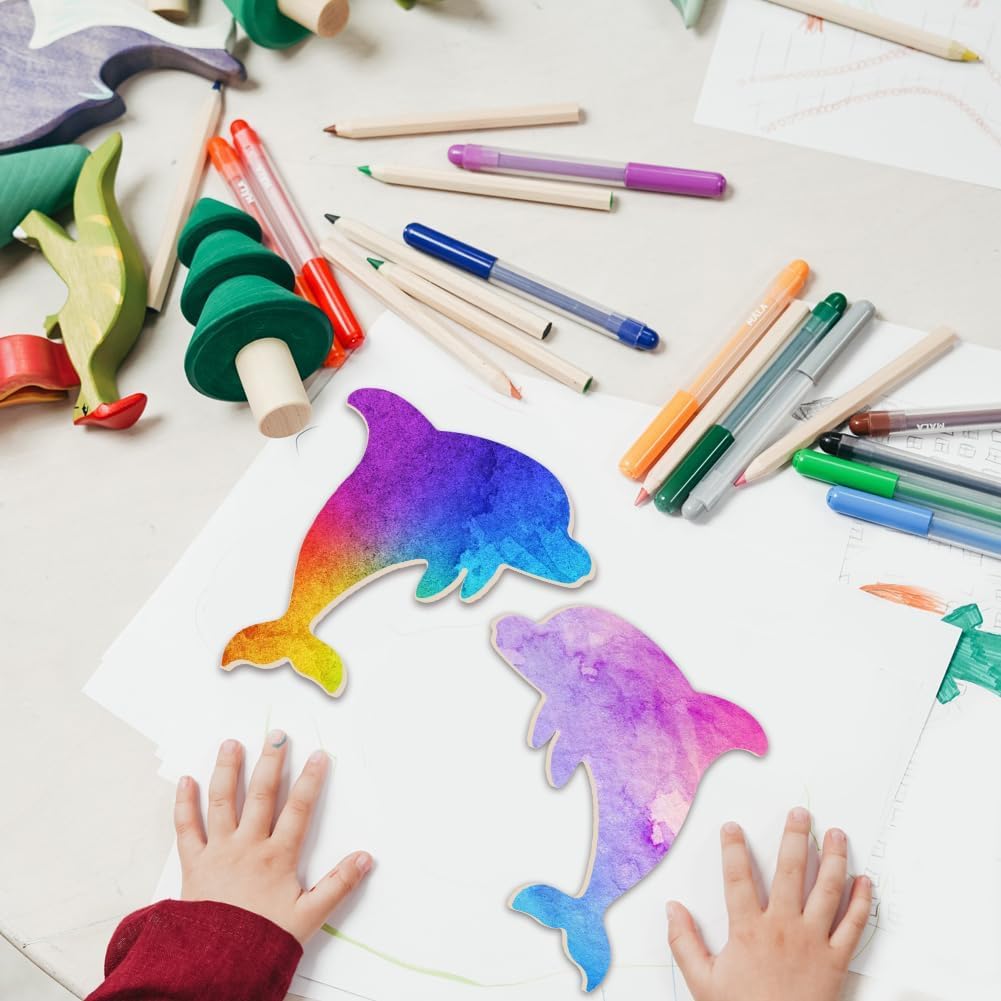 Colorful dolphin drawings on paper with art supplies and child's hands.