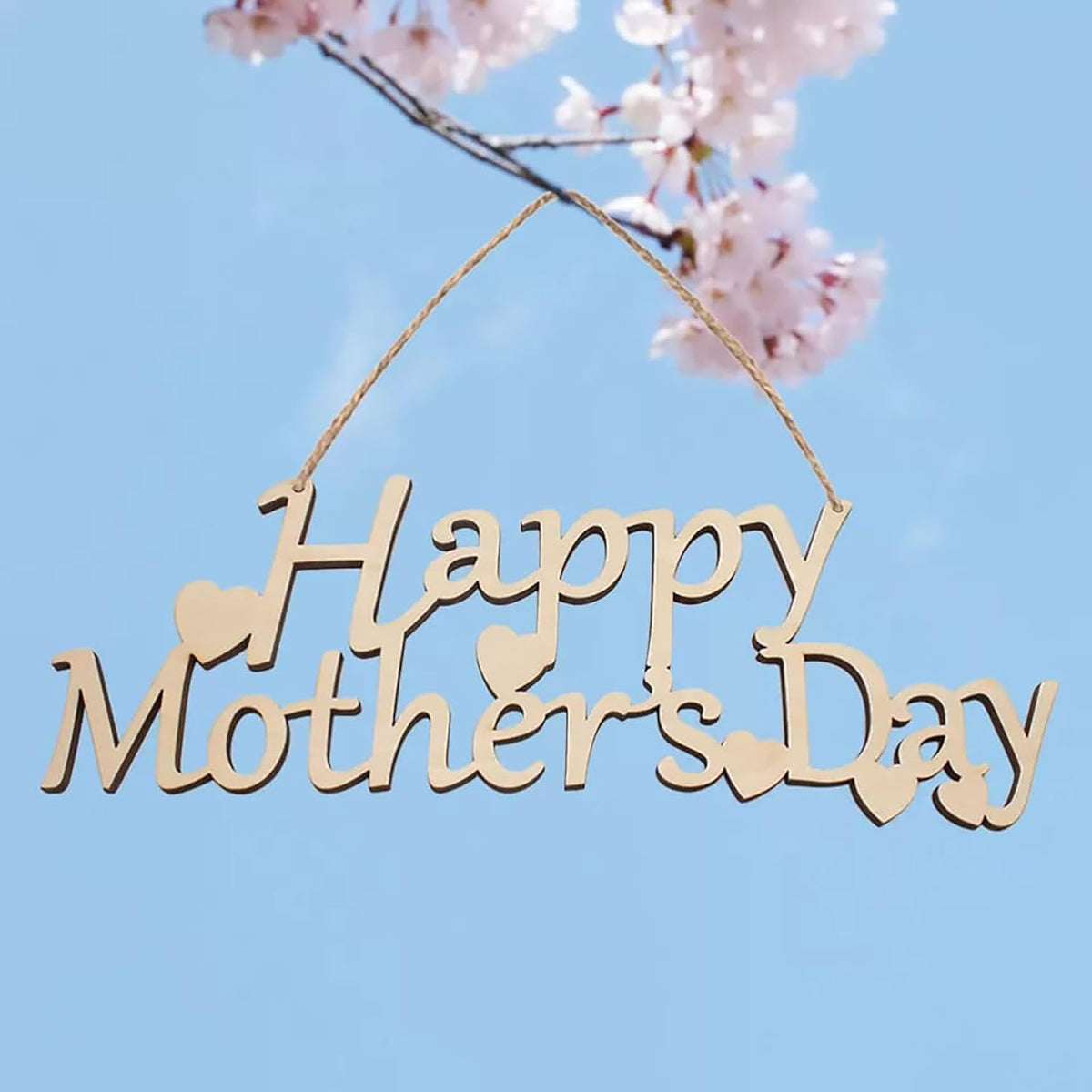 Wooden 'Happy Mother's Day' sign with cherry blossoms against a blue sky