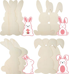 Four wooden bunny cutouts with pink bunny stickers on a white background