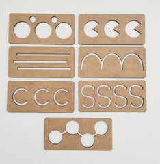 Set of cardboard cutouts with letter and shape patterns on a white background