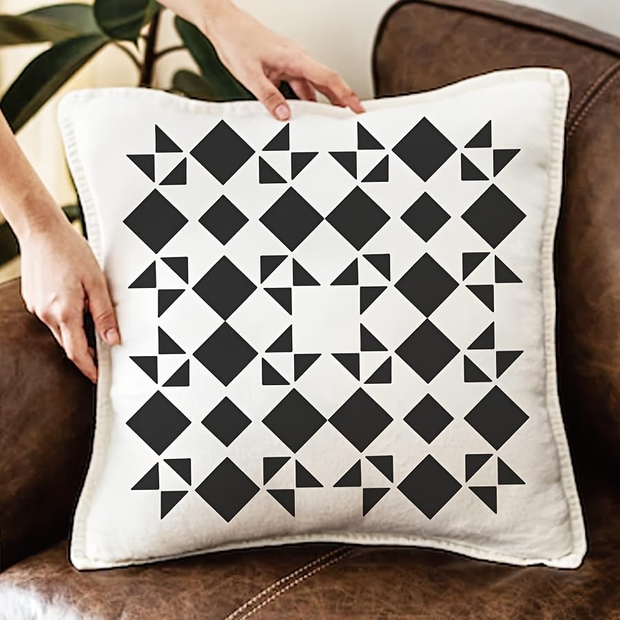 Decorative pillow with black geometric pattern on a brown couch
