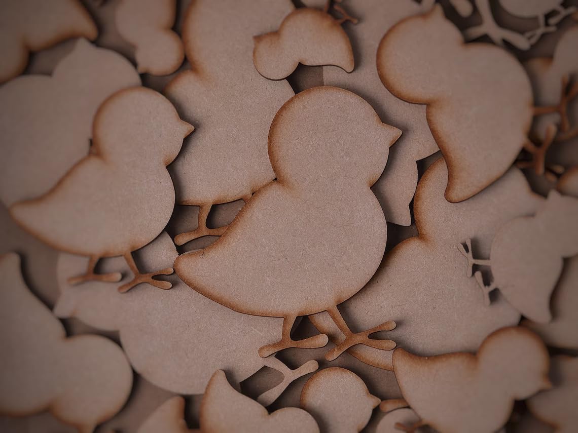 Wooden cutouts of chickens scattered on a dark background