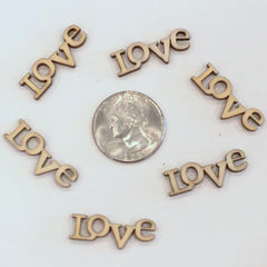 Wooden 'LOVE' letters arranged in a circle with a quarter for scale on a white background