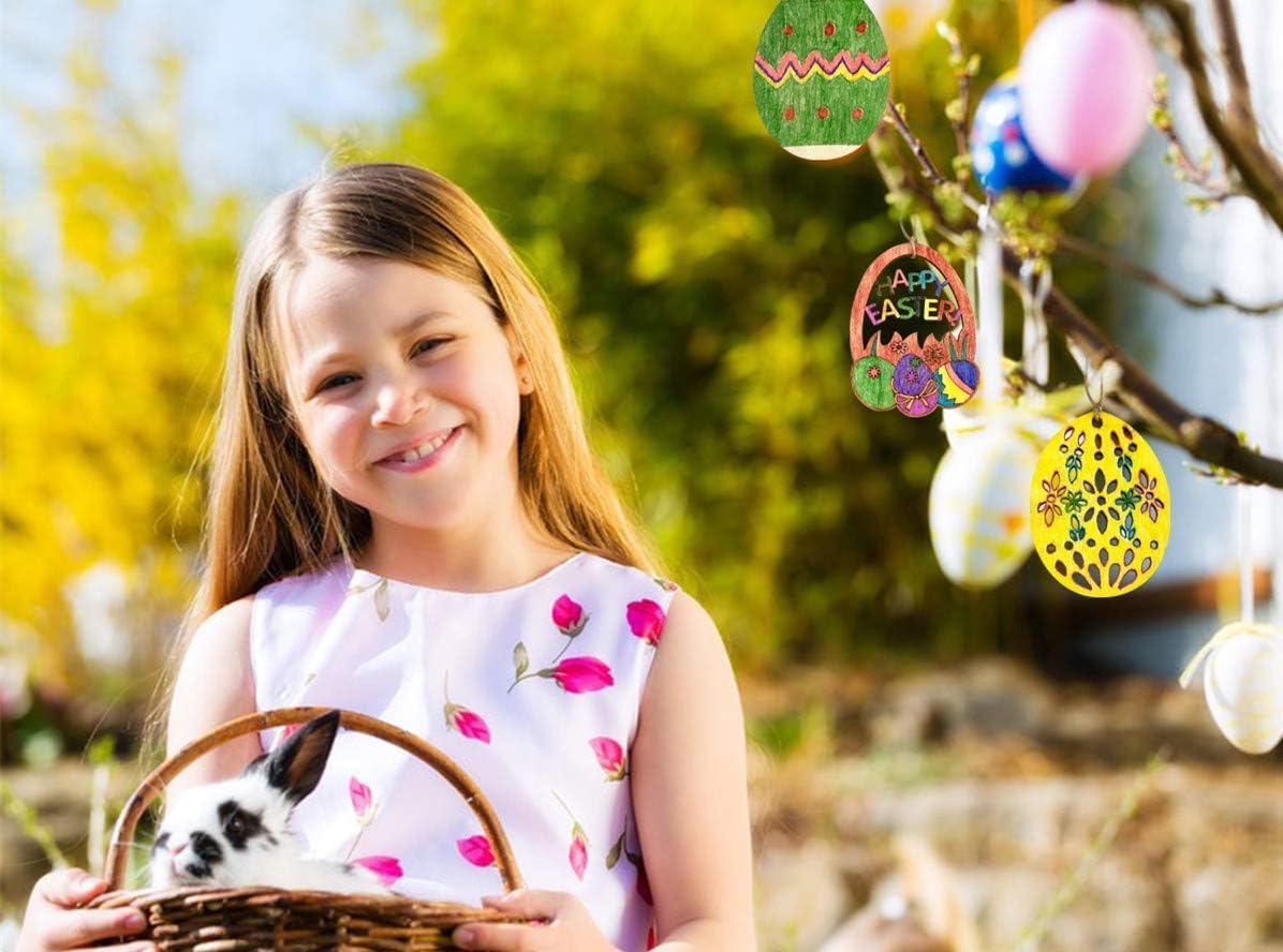 Young girl holding a basket with a small rabbit, standing outdoors with Easter decorations in the background.