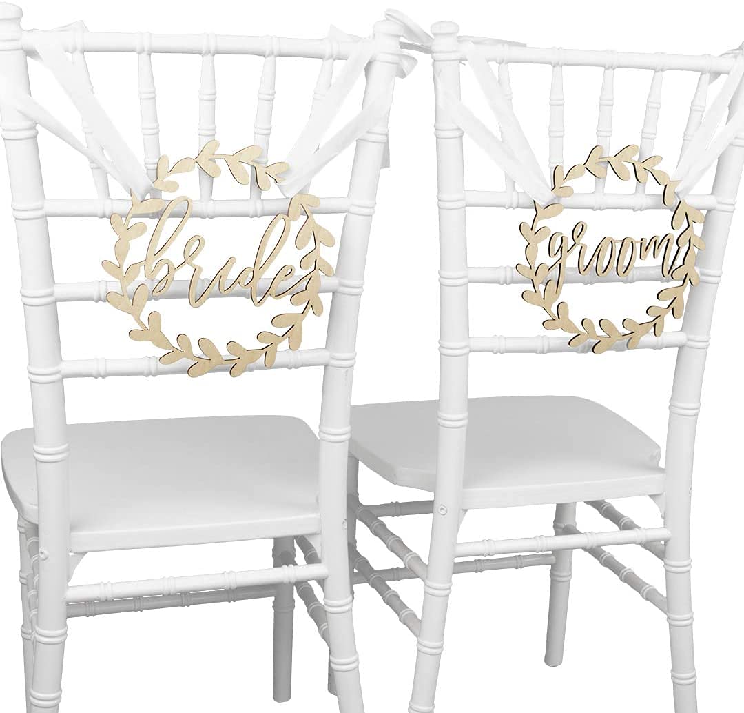 Two white chairs with 'brides' and 'groom' signs on a white background