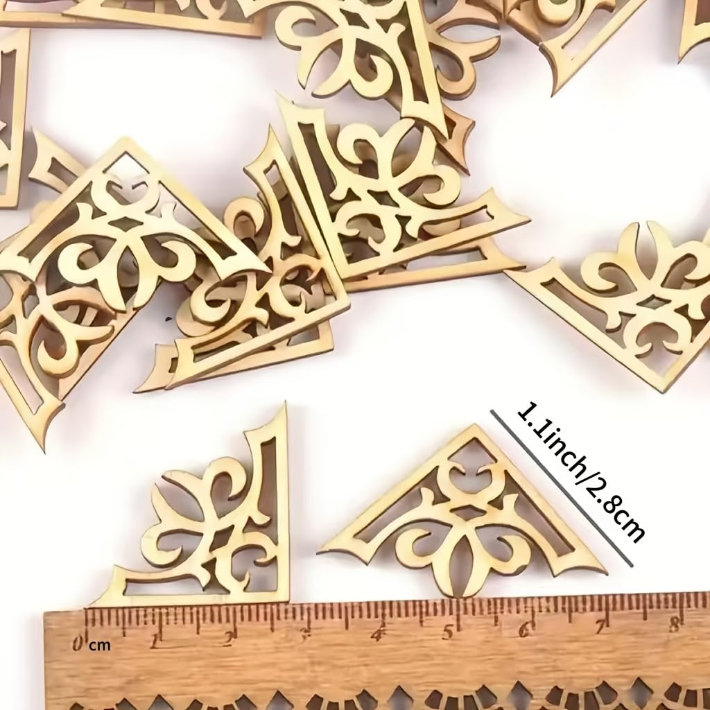 Decorative gold corner pieces with a ruler for scale on a white background