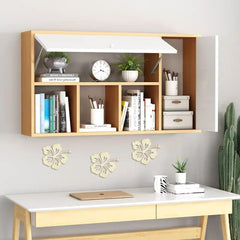 Wooden desk with wall-mounted shelves and decorative elements in a room.