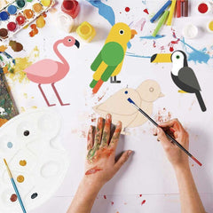 Children's art project with painted animal figures and paint supplies on a white surface.