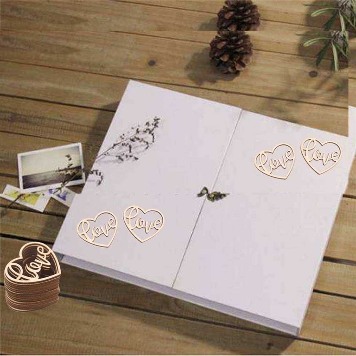 Wooden heart-shaped 'Love' decorations on a white card with a wooden surface background.