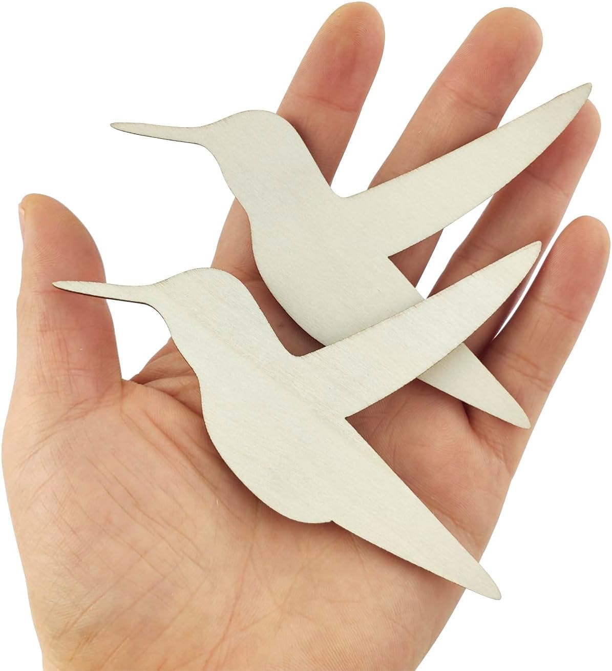 Two white bird-shaped cutouts held in a hand against a white background
