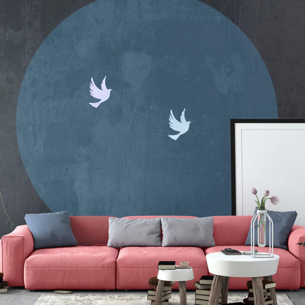 Modern living room with pink sofa, decorative pillows, and a large blue circular wall art.