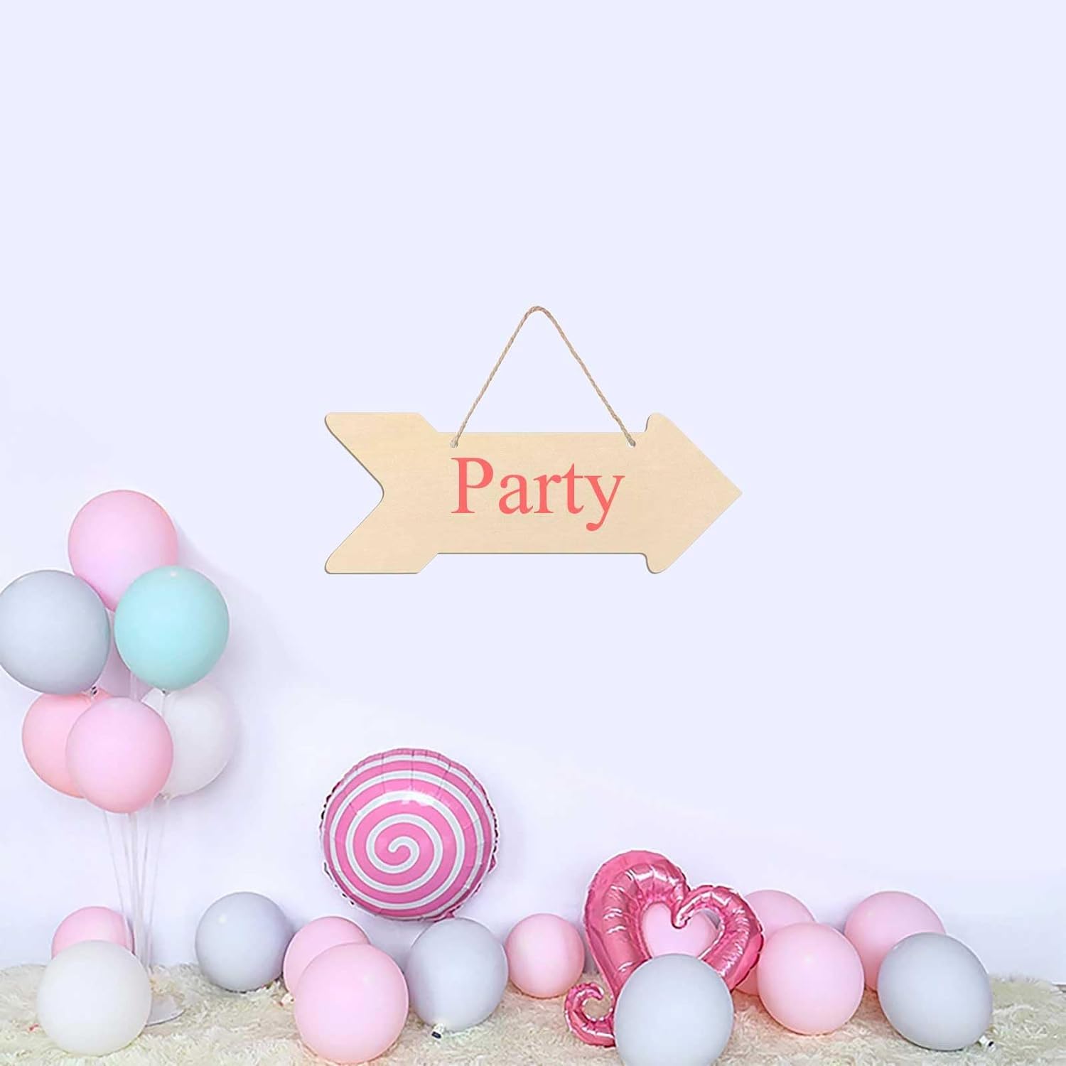 Decorative setup with balloons and a 'Party' sign on a light background