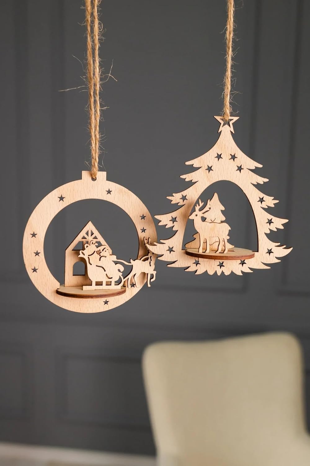 Wooden Christmas decorations with a tree and reindeer on a dark background