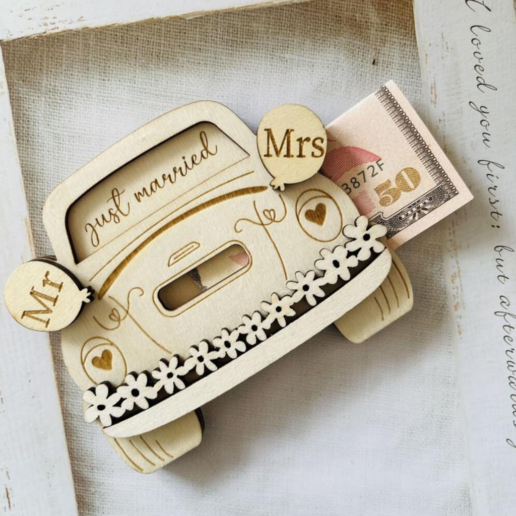 Wooden car-shaped box with 'just married' and 'Mrs' decorations on a textured surface.