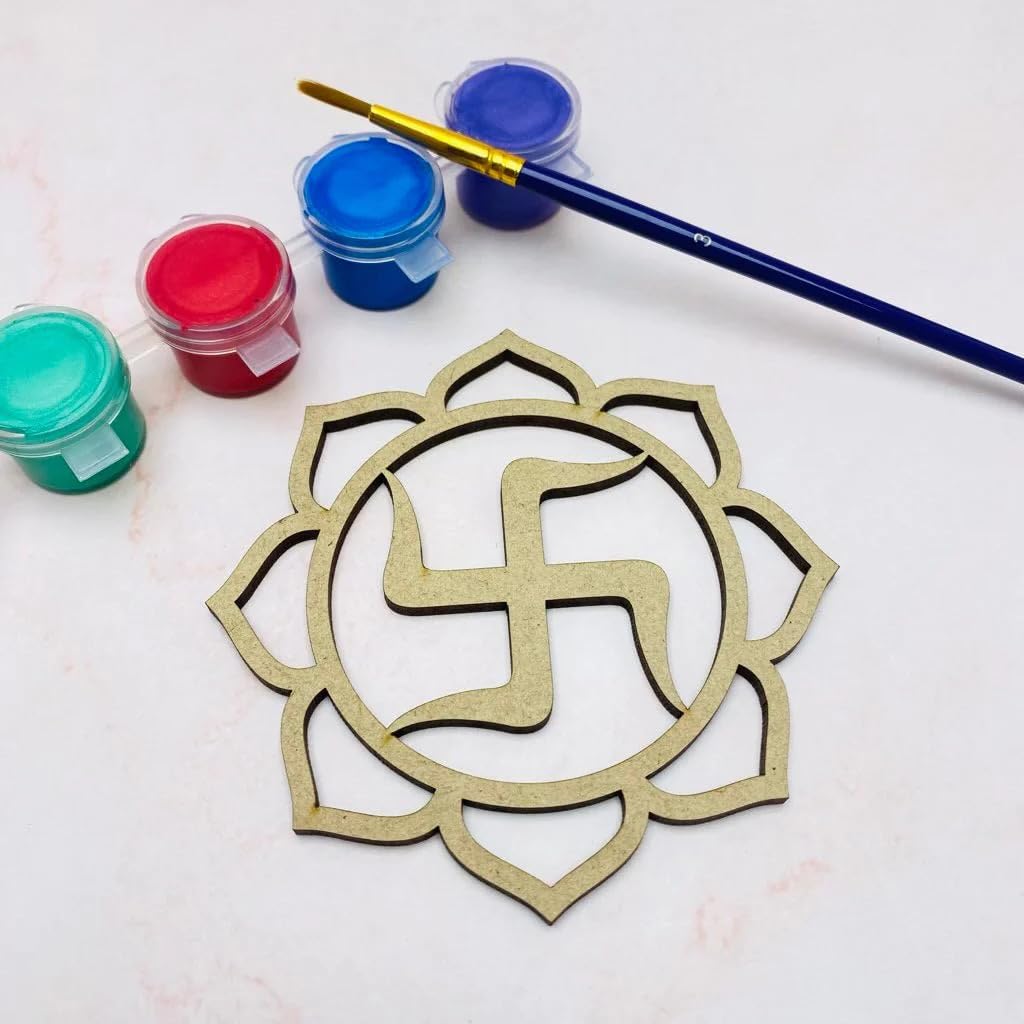Decorative metal swastika symbol with paint containers and a brush on a light background
