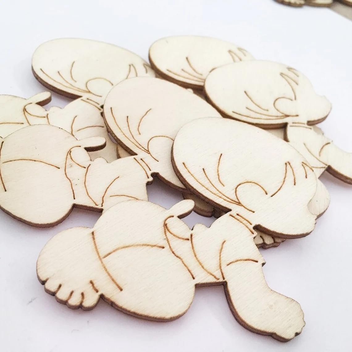 Wooden turtle-shaped cutouts on a white background